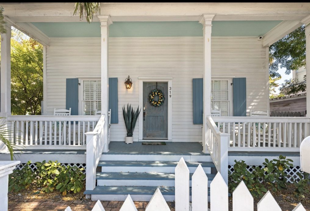 319 Grinnell Street Key West front porch before with blue-gray shutters and door