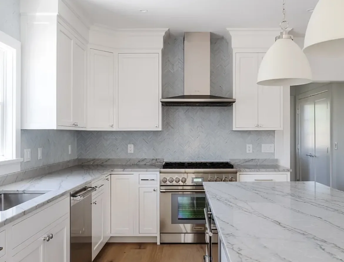 22 Tashama Lane Nantucket kitchen before redesign with plain white cabinets and marble counters