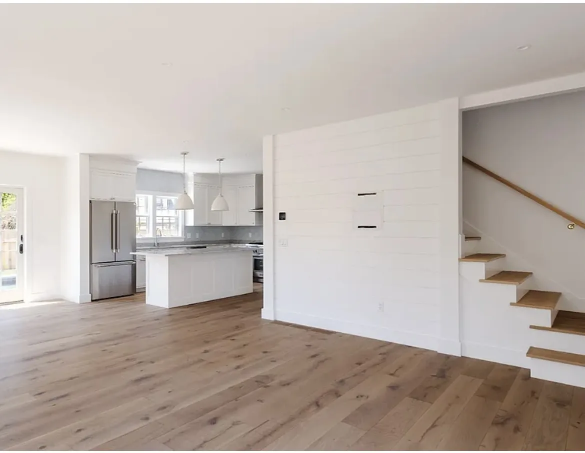 22 Tashama Lane Nantucket living room before redesign, empty open-concept space with staircase