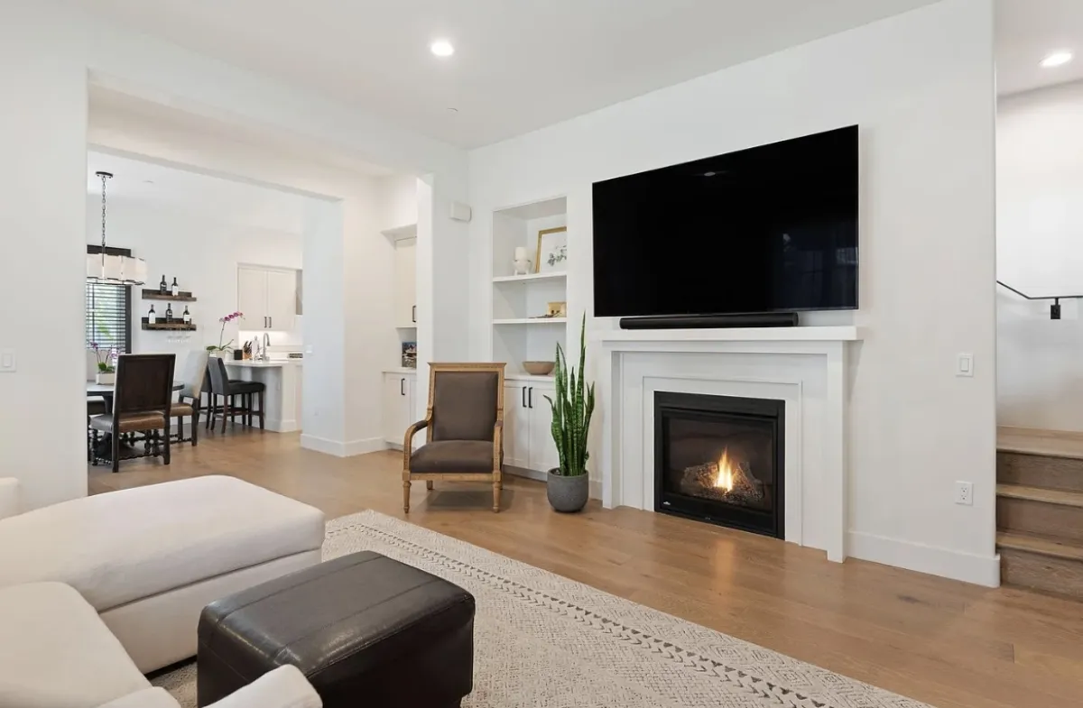 3736 State Street Santa Barbara living room before redesign with white mantel and mounted television